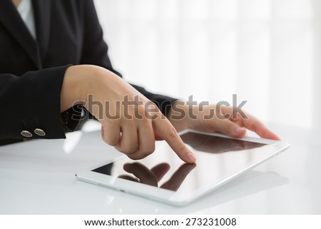 Woman hand touch white tablet with blank empty screen
