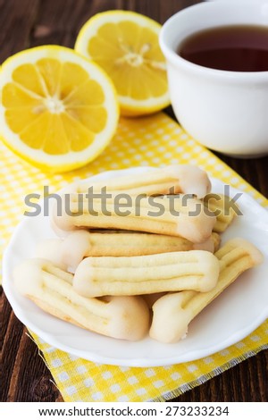 Homemade lemon churros (finger biscuits)  with glazed tops and a cup of tea