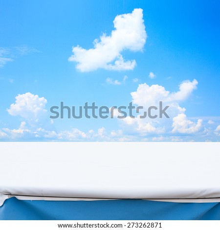 Blue sky with sun and beautiful clouds.  Empty table  for product montage texture background wallpaper. Stand for product showcase.
