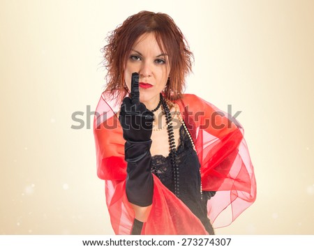 Woman in cabaret style making horn gesture 