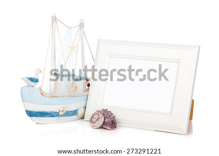 Photo frame, seashell and decor boat. Isolated on background