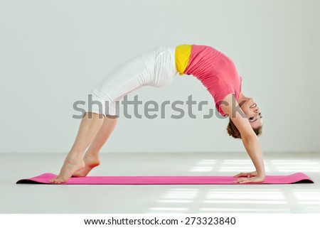 Young woman in yoga pose. Series.
