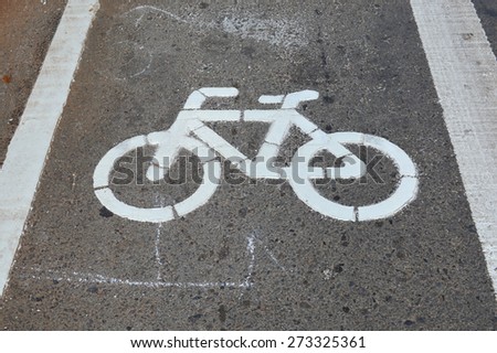 bicycle lane sign painted on the asphalt road