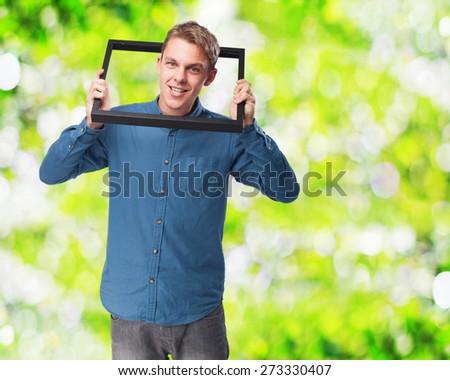happy young-man  holding a black frame