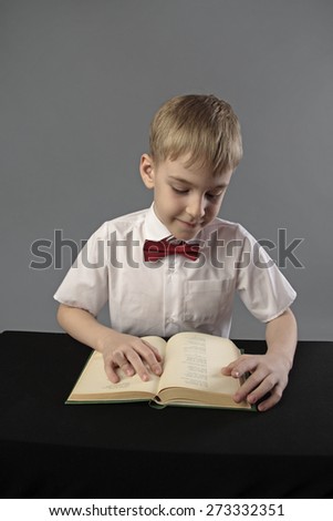 little pupil reading a book