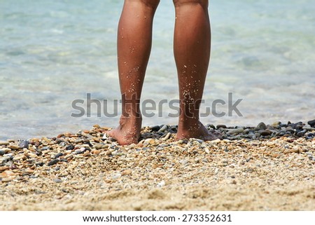 Pictures of men's legs are standing at the seaside
