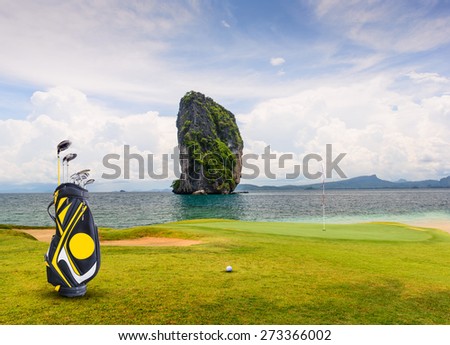 golf equipment on green and hole as background. Royalty-Free Stock Photo #273366002
