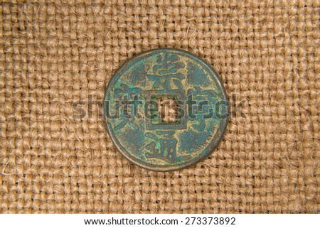  antique bronze Chinese coin on old cloth