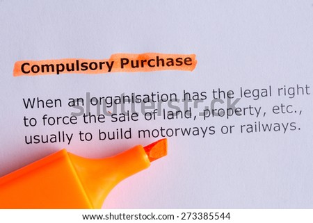 compulsory purchase word highlighted on the white paper