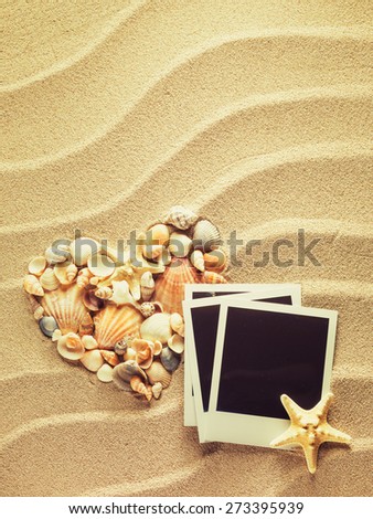 Beach sea sand with vintage empty photo cards. Summer style background. Space for your text.
