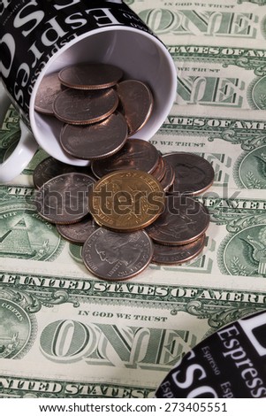 One coffee cup full of US dollars coins