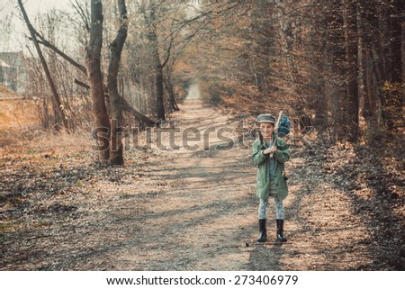 little girl goes through the woods with stuff, photo in vintage stylev