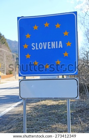 blue road sign with yellow stars in the border area between slovenia and other country