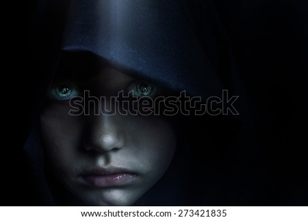 Young mysterious fantasy girl on black background.