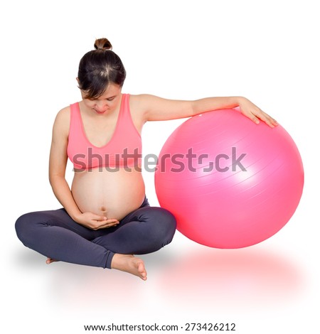 Pregnant woman yoga with exercise gymnastic ball,her looking baby in belly with love.