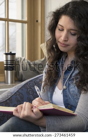 Hispanic female reading a book in the library