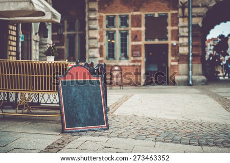 Cafe sign with space for text in an old European city