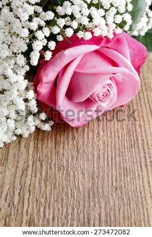 Beautiful pink roses and Gypsophila (Baby's-breath flowers). Wedding decor idea.