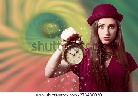 Close up portrait of beautiful elegant young woman showing alarm clock over colorful copy space