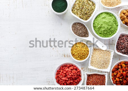 White bowls of various superfoods on white wooden  background Royalty-Free Stock Photo #273487664