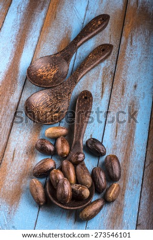 nutmeg on the wooden spoon at blue wooden table