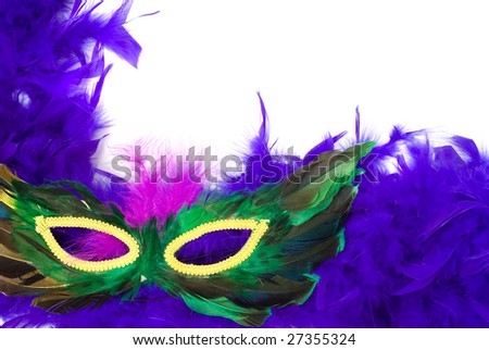 Closeup view of a feathered masquerade mask, isolated against a white background