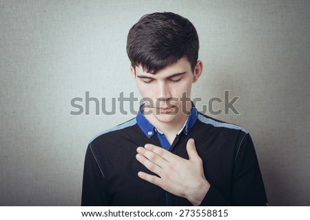 young man put his hands on his chest