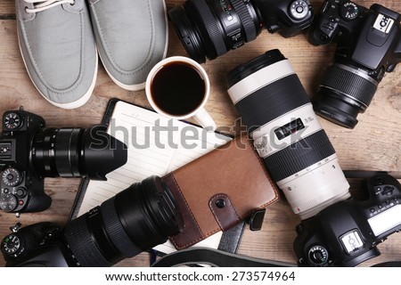 Still life with modern cameras on wooden table, top view