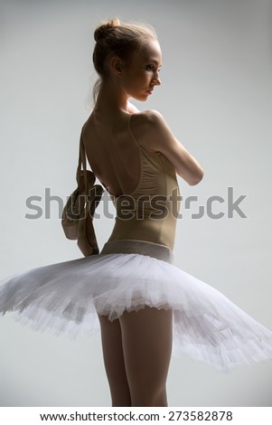 Portrait of young ballerina in white tutu