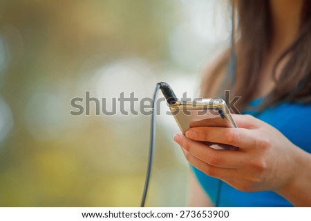 Woman listening music with headphones from ipod Royalty-Free Stock Photo #273653900