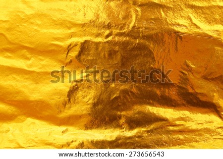 Shiny yellow leaf dark gold foil texture background Royalty-Free Stock Photo #273656543