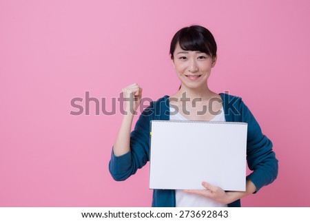 Pretty asian woman holding white blank billboard sign