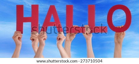 Many Caucasian People And Hands Holding Red Straight Letters Or Characters Building The German Word Hallo Which Means Hello On Blue Sky