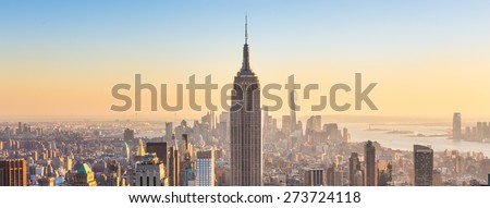 New York City. Manhattan downtown skyline with illuminated Empire State Building and skyscrapers at sunset. Panoramic composition. Royalty-Free Stock Photo #273724118