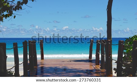 wooden footpath to the coulurful indian ocean