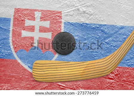 Hockey puck, hockey stick and the image of the Slovak flag on ice