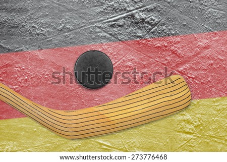 Hockey puck, hockey stick and the image of the German flag on the ice
