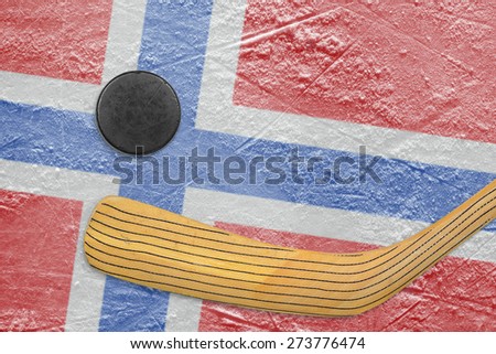 Hockey puck, hockey stick and the image of the Norwegian flag on the ice