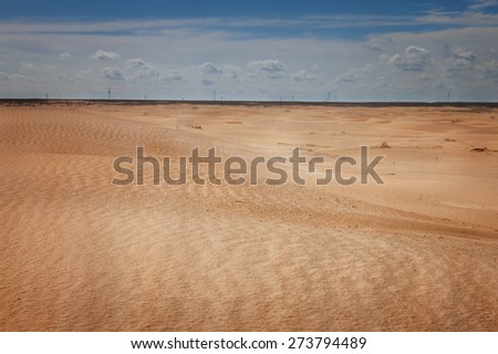 Landscape. The desert under a blue sky with clouds