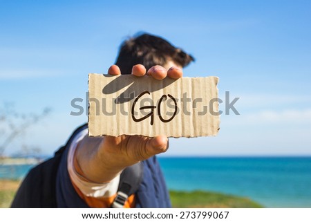 Hipster man holding a paper with text Go