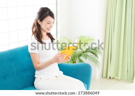 young attractive asian woman who reads a book