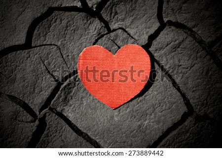 paper red heart on cracked earth, love concept
