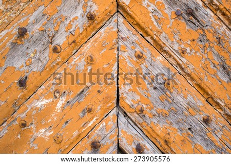 old wooden door in vintage style with rusty metallic nails