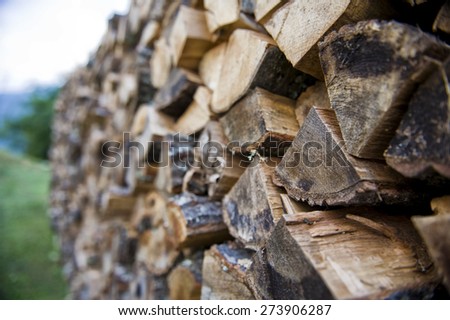 Dry chopped firewood logs stacked up on top of each other in a pile
