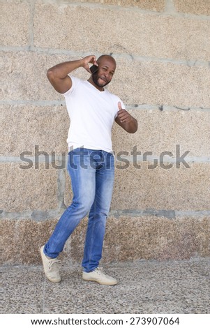 black man with ok symbol and mobile phone