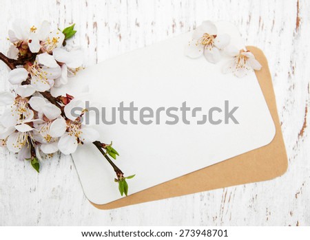 spring apricot blossom with card on a wooden background