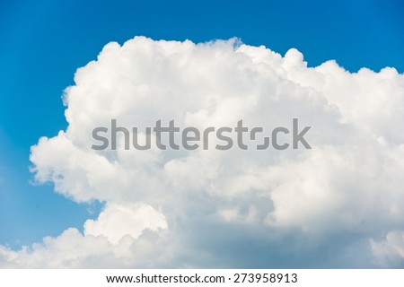 Huge fluffy white clouds on blue sky