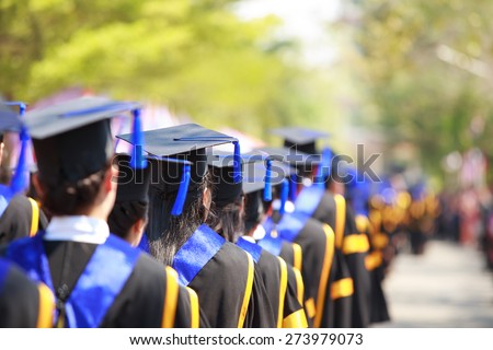 Crowd image of students at graduation ceremony from behind Royalty-Free Stock Photo #273979073
