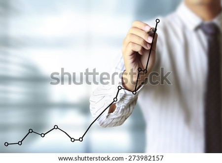 Business man drawing a graph 