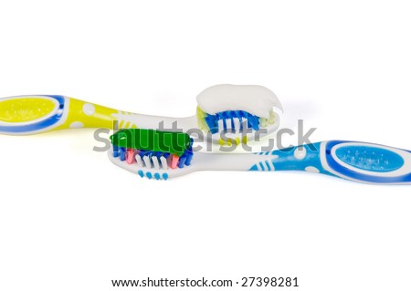 Two tooth-brushes with different paste on a white background
